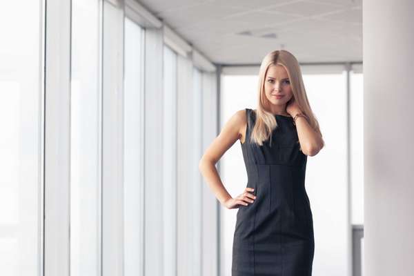woman in a black dress with her hand on her hip