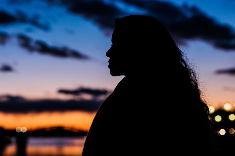 woman silhouette tranquillity sunset background, travel in Tajo river. Toledo, Castilla la mancha