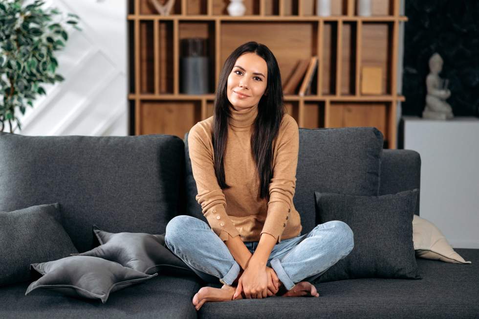 woman sitting on a couch with her legs crossed