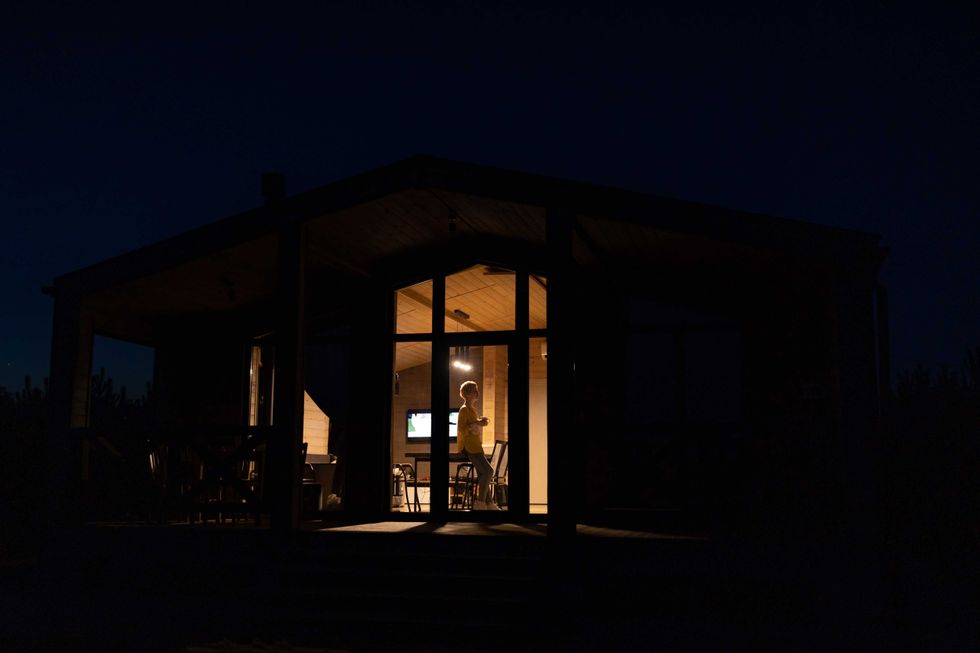 woman standing in front of a window at night
