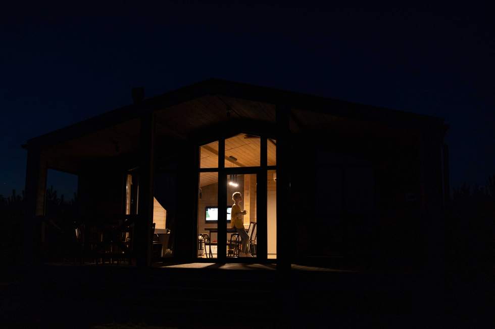 woman standing in front of a window at night
