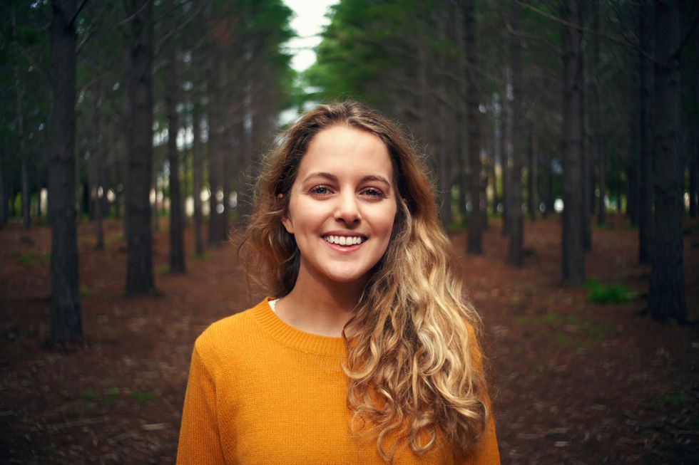 woman standing in the forest