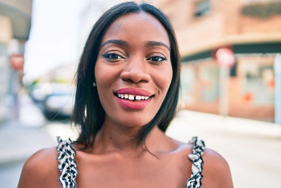 Young african american woman smiling happy walking at street of city
