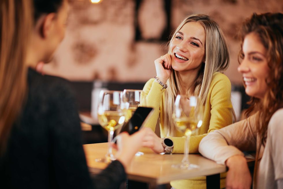 Young woman sitting in cafe and drinking coffee.