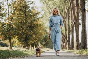 Young woman with her pet french bulldog in park