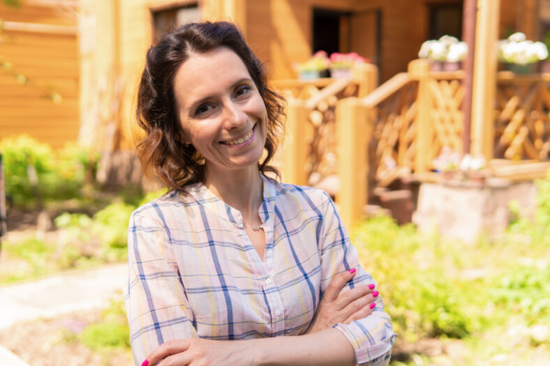 Portrait of a gardener's woman in the courtyard of her house.