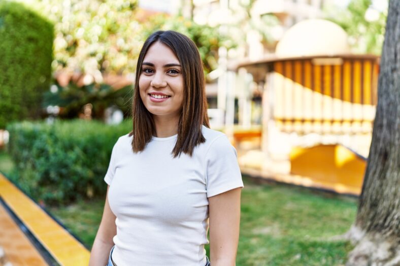 Young beautiful woman smiling happy outdoors on a sunny day of summer