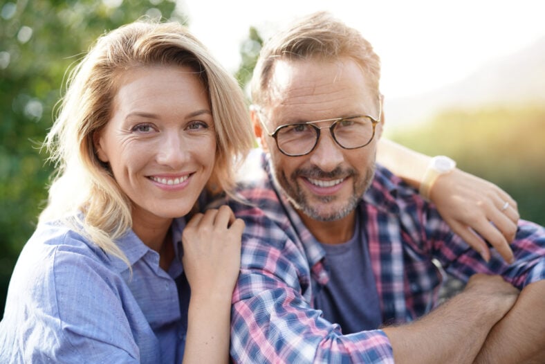 Portrait of mature couple relaxing in outdoor sofa