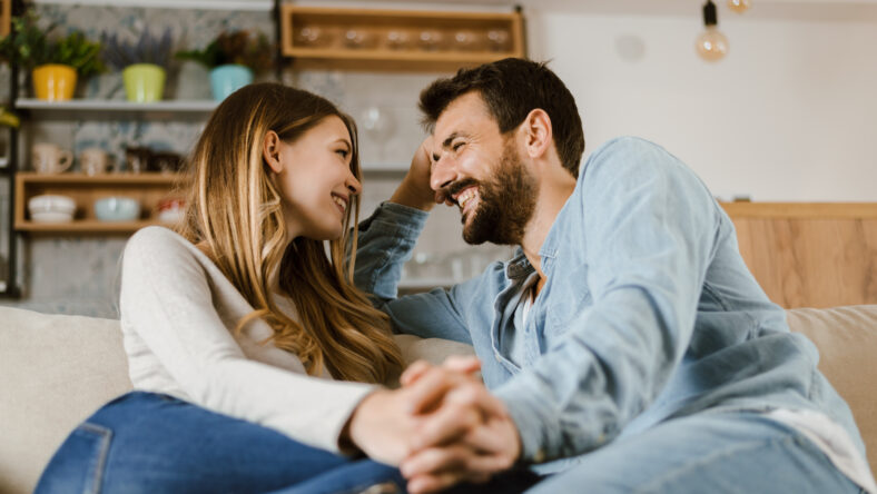 Loving happy couple talking to each other at home
