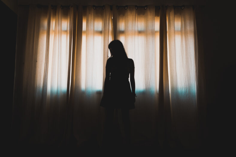 silhouette of woman in window