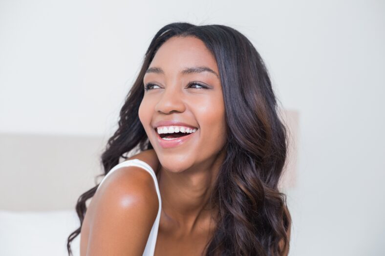 Beautiful woman smiling on bed