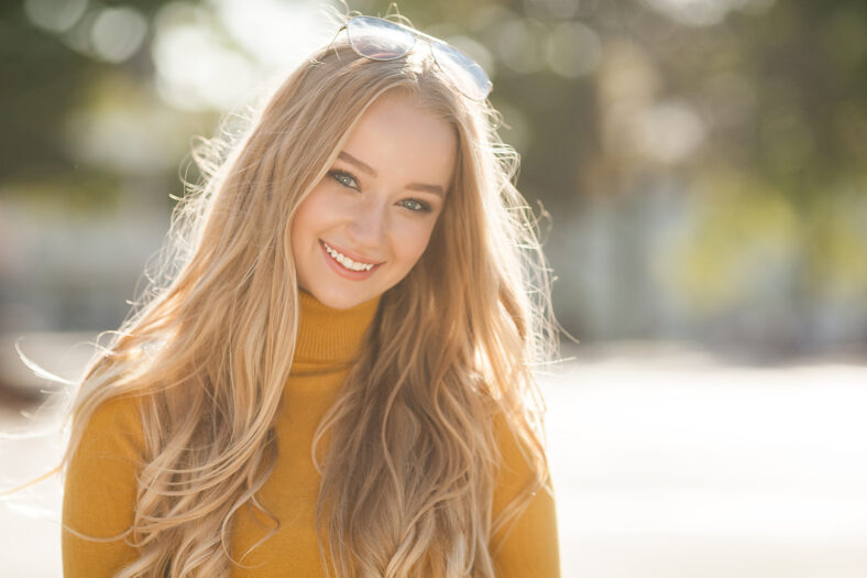 Closeup portrait of young beautiful woman. Female outdoors.