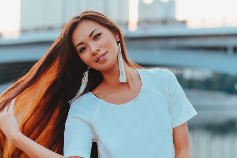 Young asian woman with long hair morning city portrait