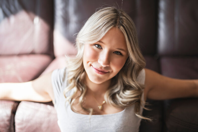 A teen Girl sitting on a couch at home