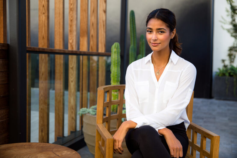 Gorgeous mixed race woman sitting relaxed with peace of mind on home and garden patio