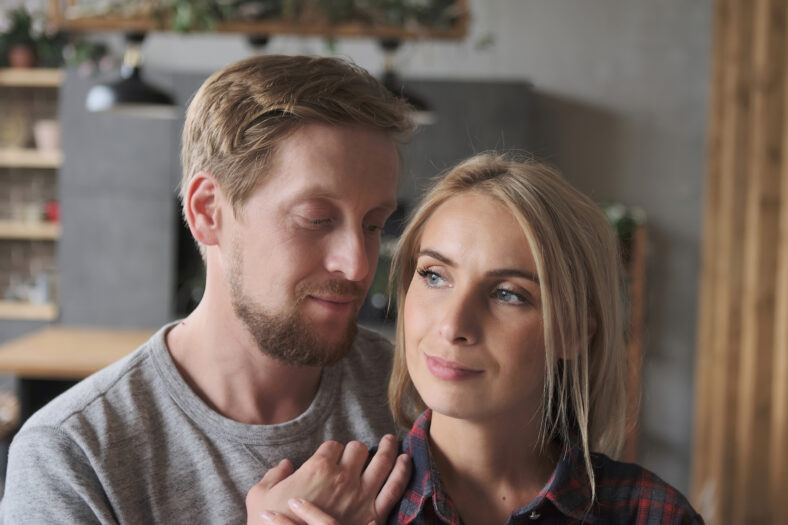 Closeup happy European couple hugging to each other enjoying perfect romantic relationship spending time together. Face of beautiful girlfriend and handsome boyfriend feeling love and tenderness