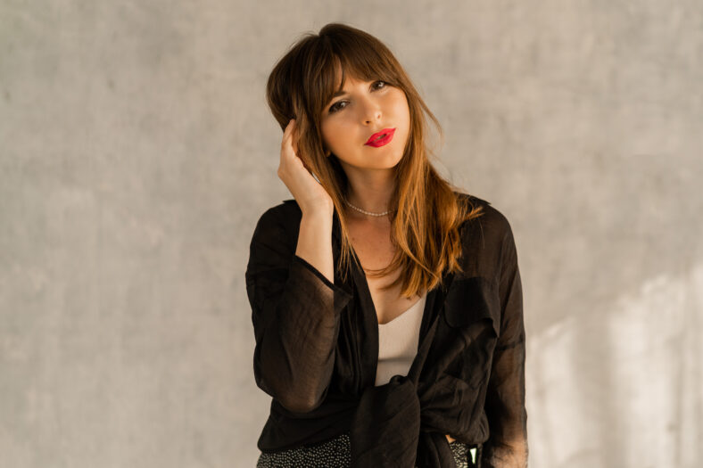 Fashion photo of brunette female with red lips in casual elegant autumn autfit. posing over grey urban wall.