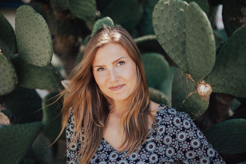 woman standing in front of cacti
