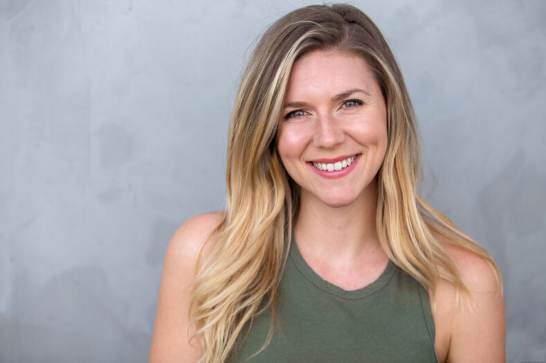 Cute natural blonde woman smiling with perfect white teeth and g