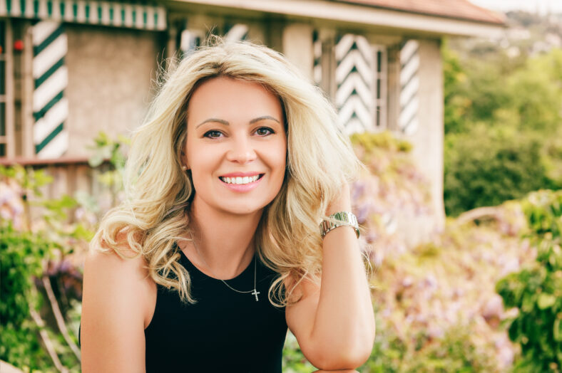 Outdoor portrait of beautiful blond woman resting outdoors