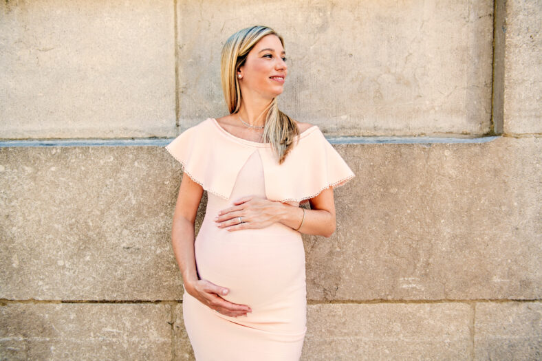A Portrait of a pregnant woman in city street