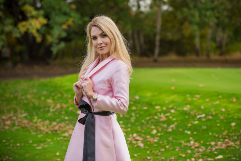 Spring natural romantic outfit, lady in pink coat at park