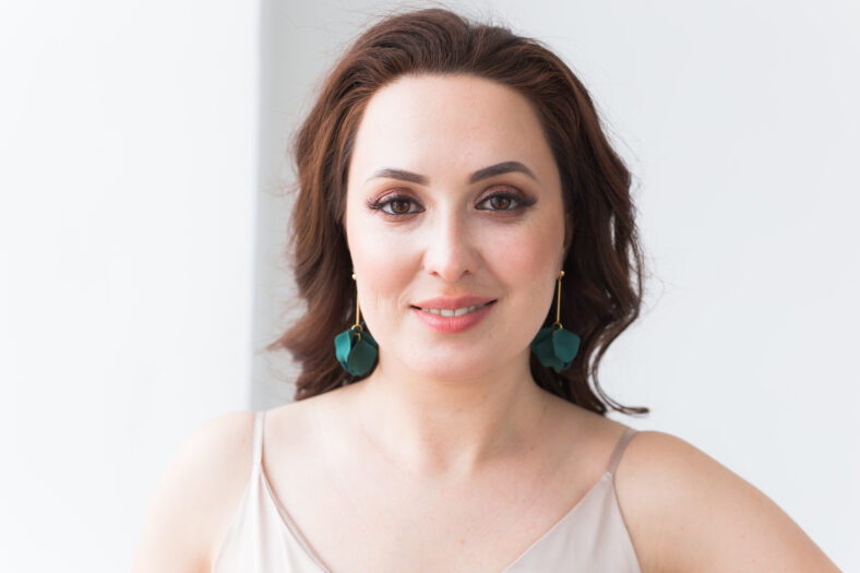 Elegant woman with silver jewelry earrings and chain, close up portrait. Accessories, jewelry and bijouterie concept