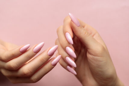 Girl's hands with a beautiful pink manicure
