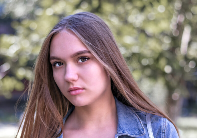 cute young girl 16 years old with long brown hair and brown eyes, close-up portrait