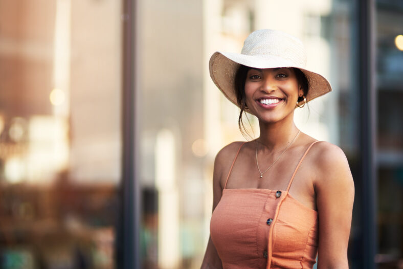 Portrait of an attractive young woman feeling cheerful while out and about in the city.