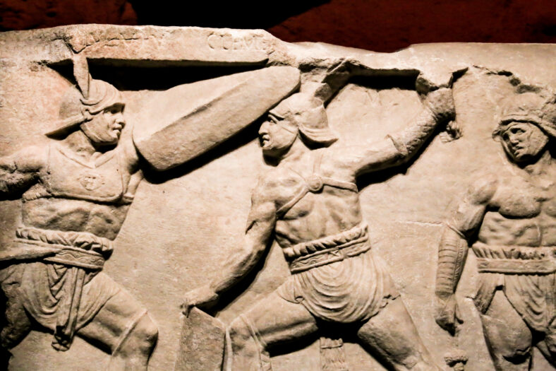 Relief of Gladiator Games made of marble exhibited at the Archaeological Museum of Alicante in Summer.