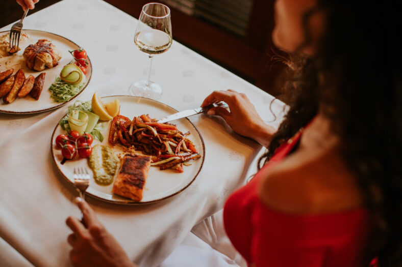 Handsome young couple having lunch with white wine in the restaurant