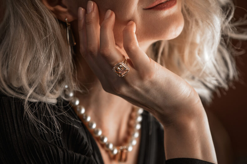 Romantic portrait of a girl dressed in an elegant dress and expensive jewelry