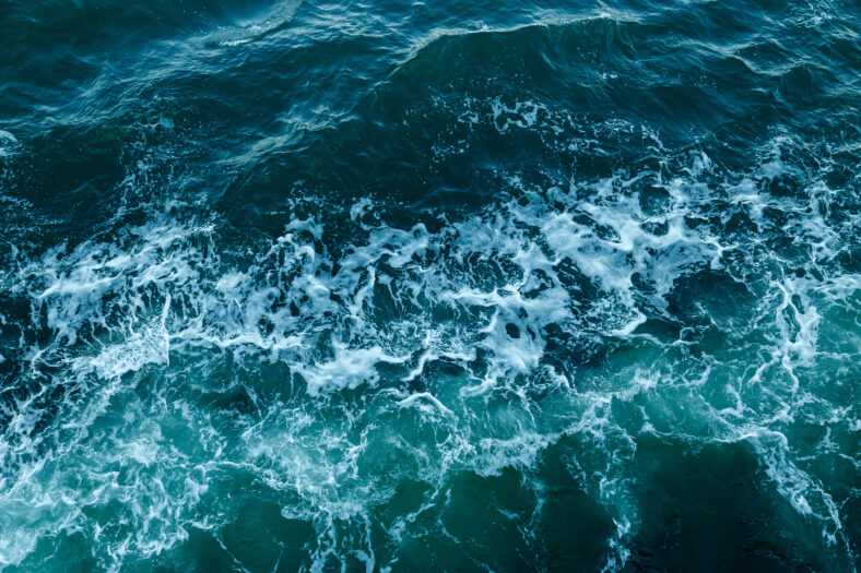 Blue sea texture with waves and foam