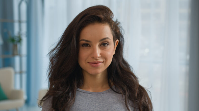Portrait brunette woman Caucasian female girl fitness instructor trainer healthy sportswoman yogi athlete happy smiling beautiful slim fit lady looking camera smile health beauty sport workout at home. High quality 4k footage