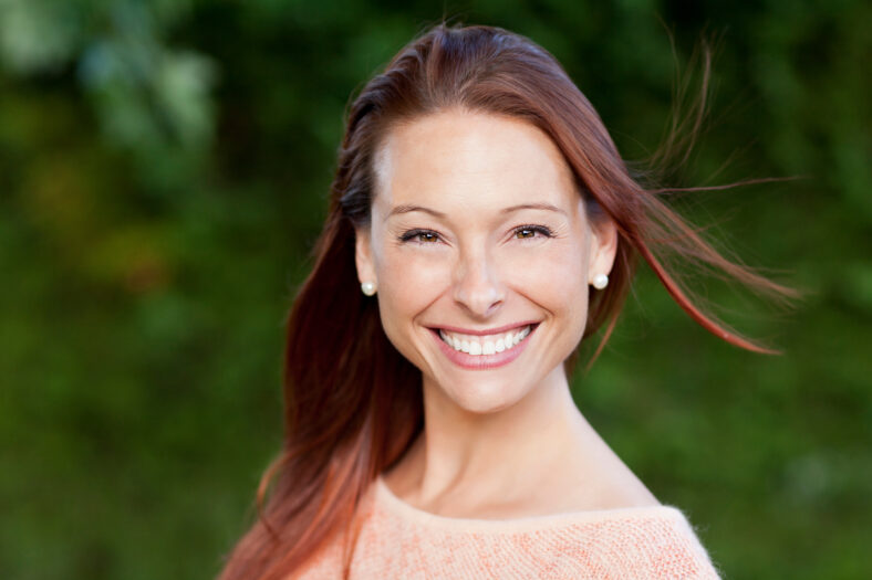Smiling Woman Outside Looking At The Camera