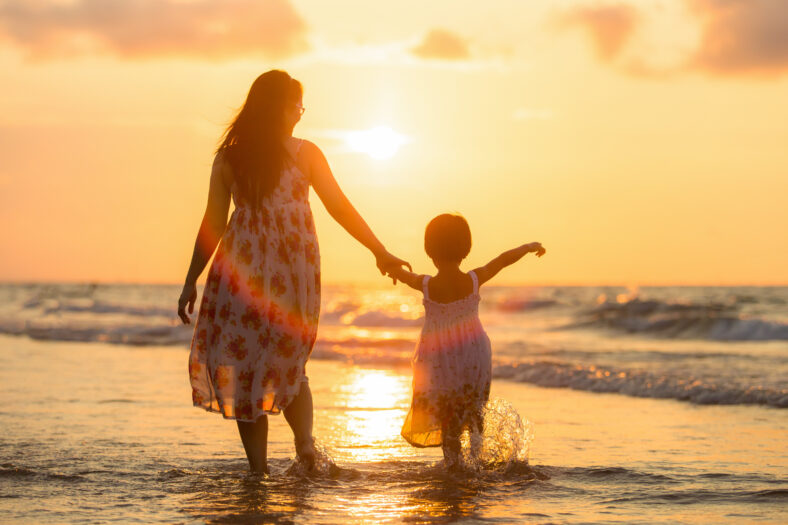 Mother with her daughter on the beach