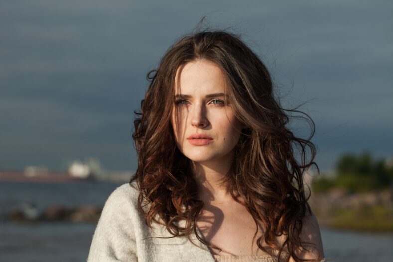 Close-up portrait of brunette woman 30 s years old resting outdoors