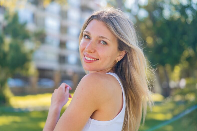 Young blonde woman at outdoors . Portrait