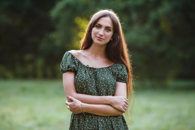 Young smiling woman portrait on grass background