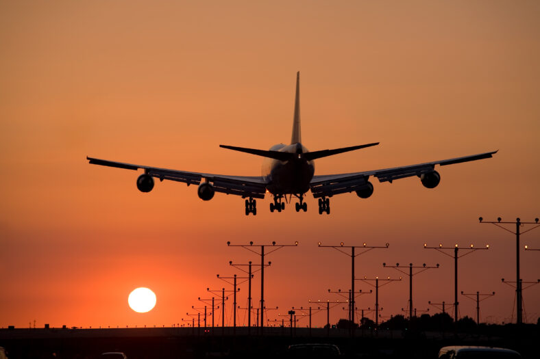 Jumbo jet coming in for a sunset landing