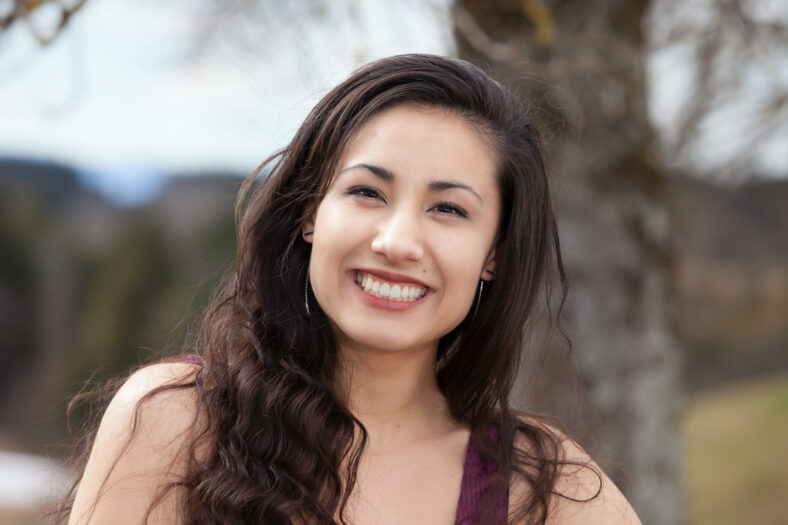 asian woman outdoor smiling to camera