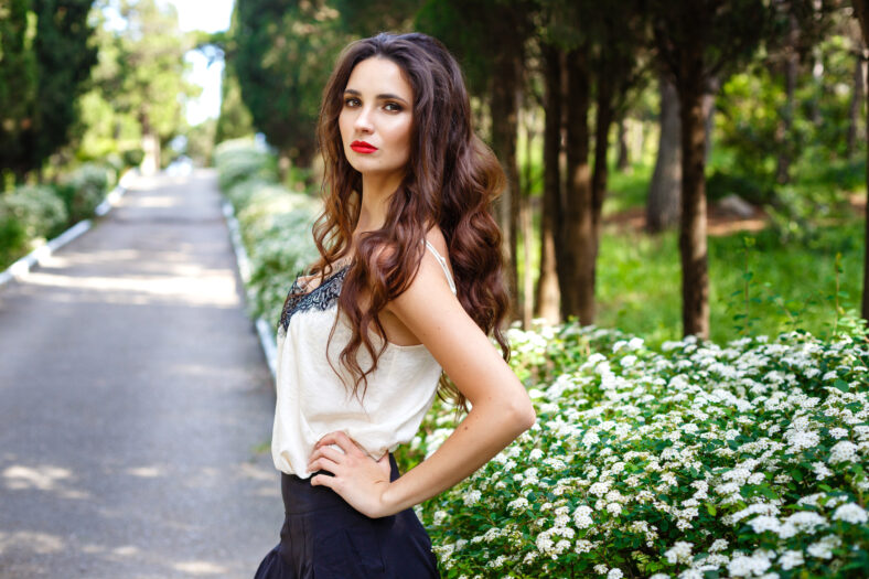 Business woman thinking in Park. Young female professional businesswoman thinking smiling happy outdoors.