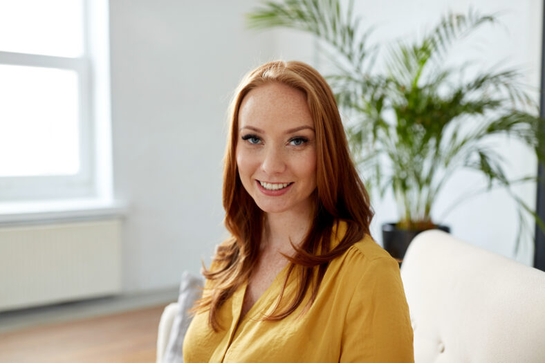 business and people concept - portrait of smiling redhead woman at office