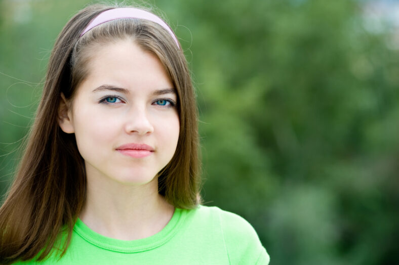 portrait of a young smiling beautiful european girl looking into camera