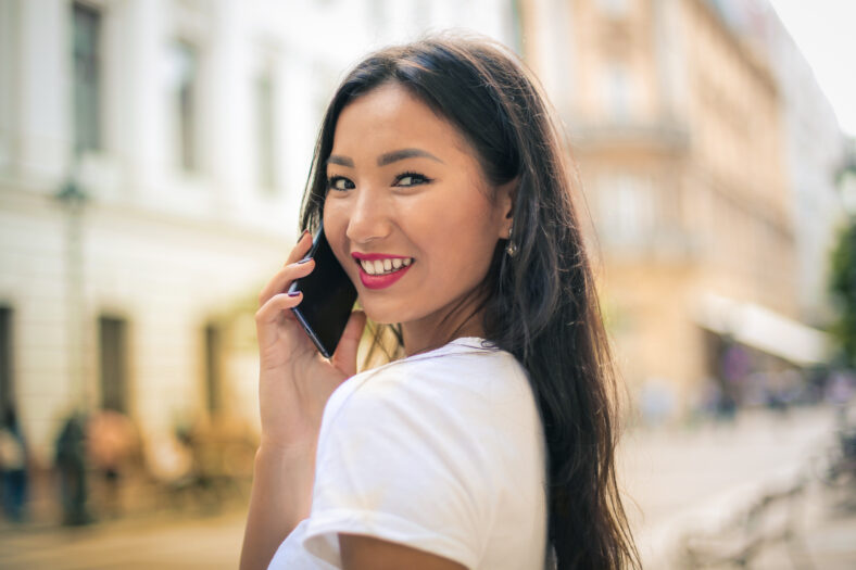 Smiling pretty woman doing a phone call