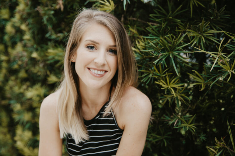Cute Attractive Blonde Young Woman in Stripes Smiling and Posing for Camera Downtown