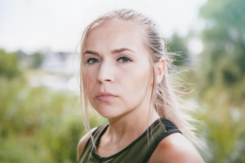blonde sports woman jogs in park