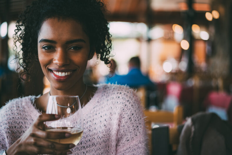 Black woman drinking wine