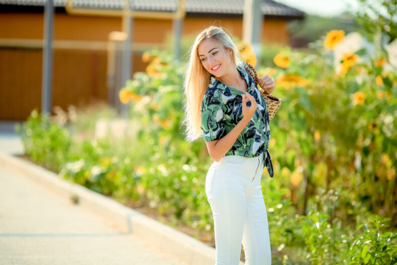 beautiful blonde in the garden of a sunny summer day.